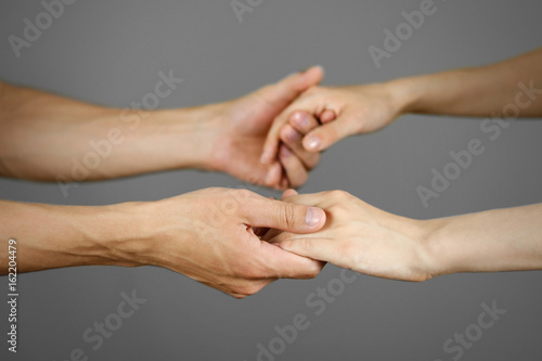 Male hand holding female hand. Isolated