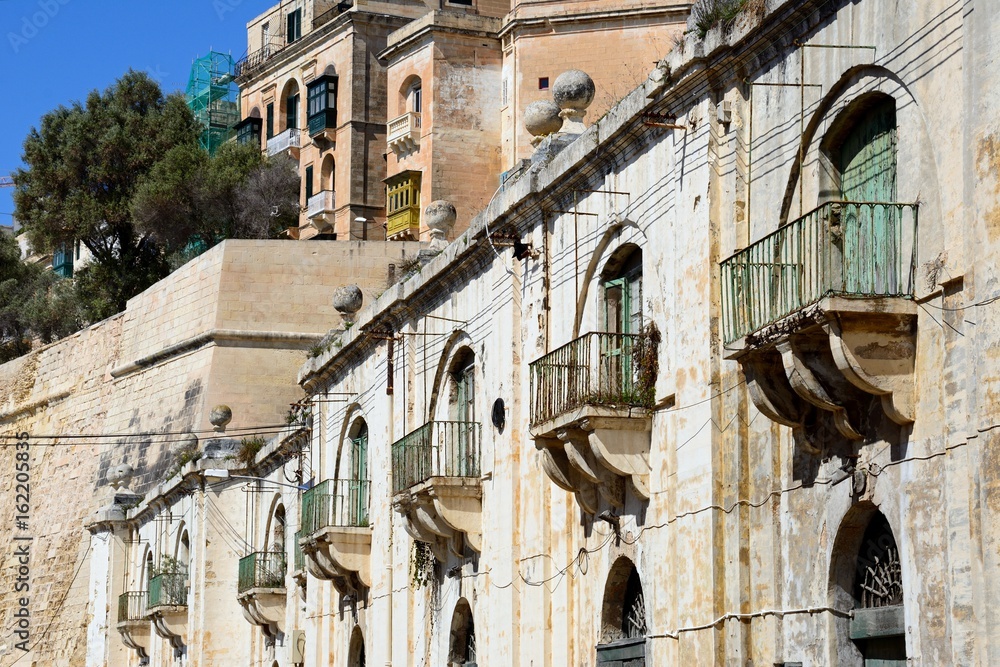 Traditional buildings with balconies near the waterfront, Valletta, Malta.