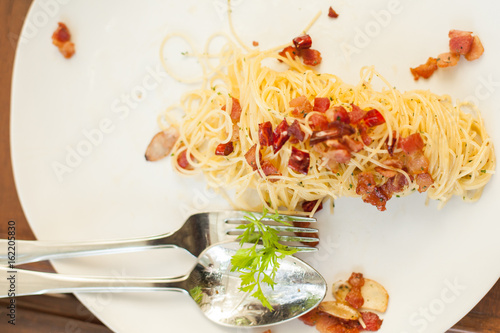 spaghetti becon on white plate in resturant