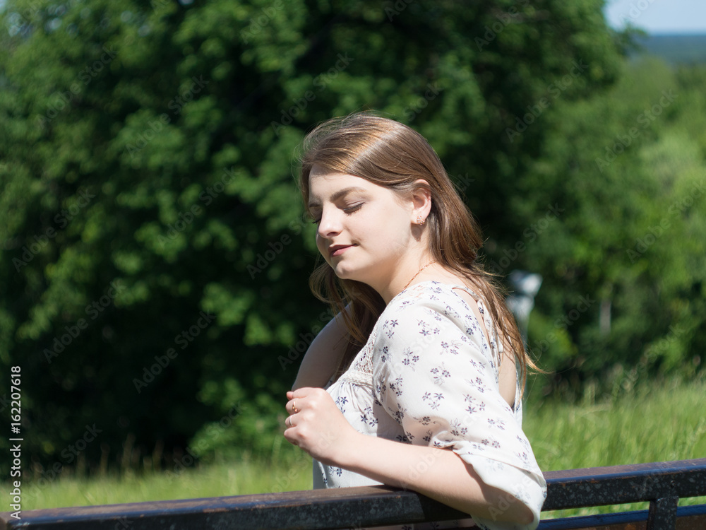 girl with closed eyes, relaxation outdoors in a Sunny day girl with closed eyes, relaxation outdoors in a Sunny day