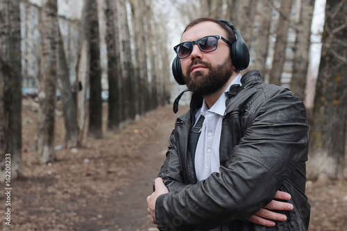 man with beard and headphones in the park © alexkich