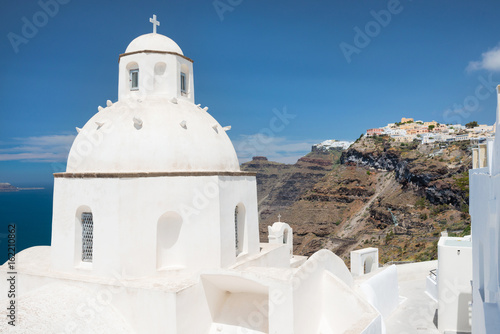 White cupola of church with Firostefani and Imerovigli villages in background, Santorini, Greece