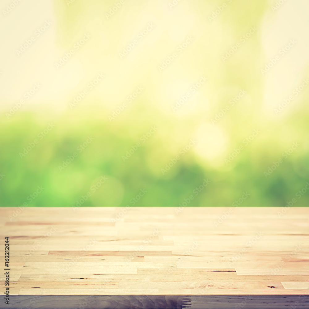 Wood table top on green bokeh abstract background, vintage tone Wood table top on green bokeh abstract background, vintage tone
