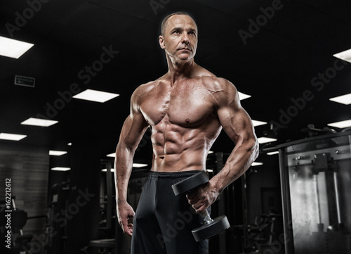 Brutal bodybuilder athletic man with six pack  perfect abs  shoulders  biceps  triceps and chest    Brutal bodybuilder athletic man with six pack  perfect abs  shoulders  biceps  triceps and chest
