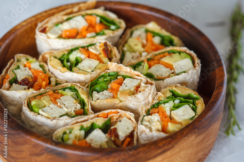 Healthy vegan tofu tortilla wraps with tofu and vegetables. Love for a healthy raw food concept.