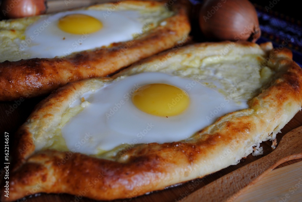 Khachapuri in Adjara with the egg. The Georgian cuisine. Khachapuri in Adjara with the egg. The Georgian cuisine.