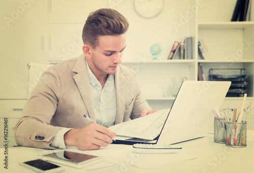 Portrait of businessman working in modern office