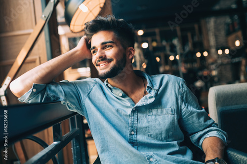 Portrait of young handsome man in blue shirt