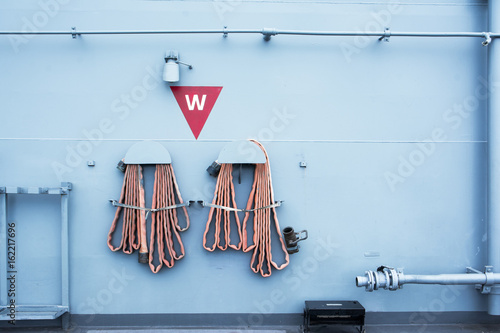 Fire hose hanging on the wall in battle ship