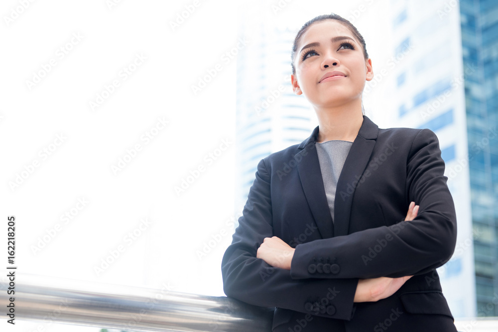 Asian businesswoman standing and crossing her arms Asian businesswoman standing and crossing her arms
