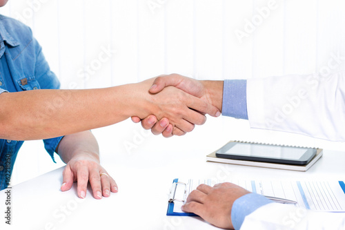 Doctor making handshake with patient
