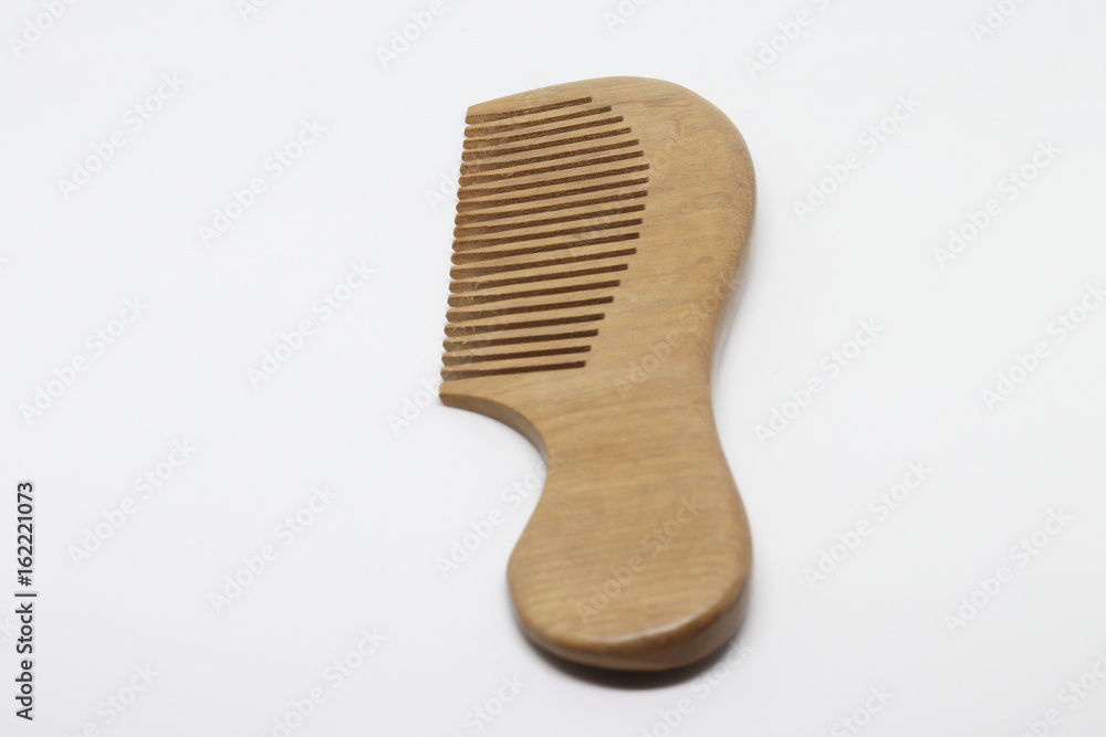 Classic Wooden comb isolated on white baclground Classic Wooden comb isolated on white baclground