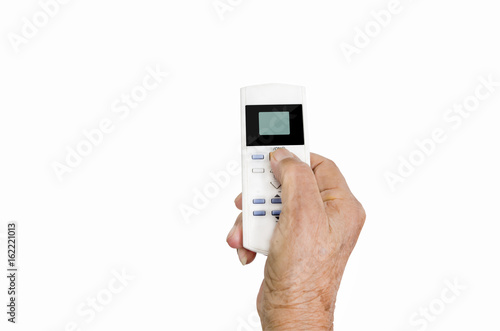 Hand holding remote control on white background