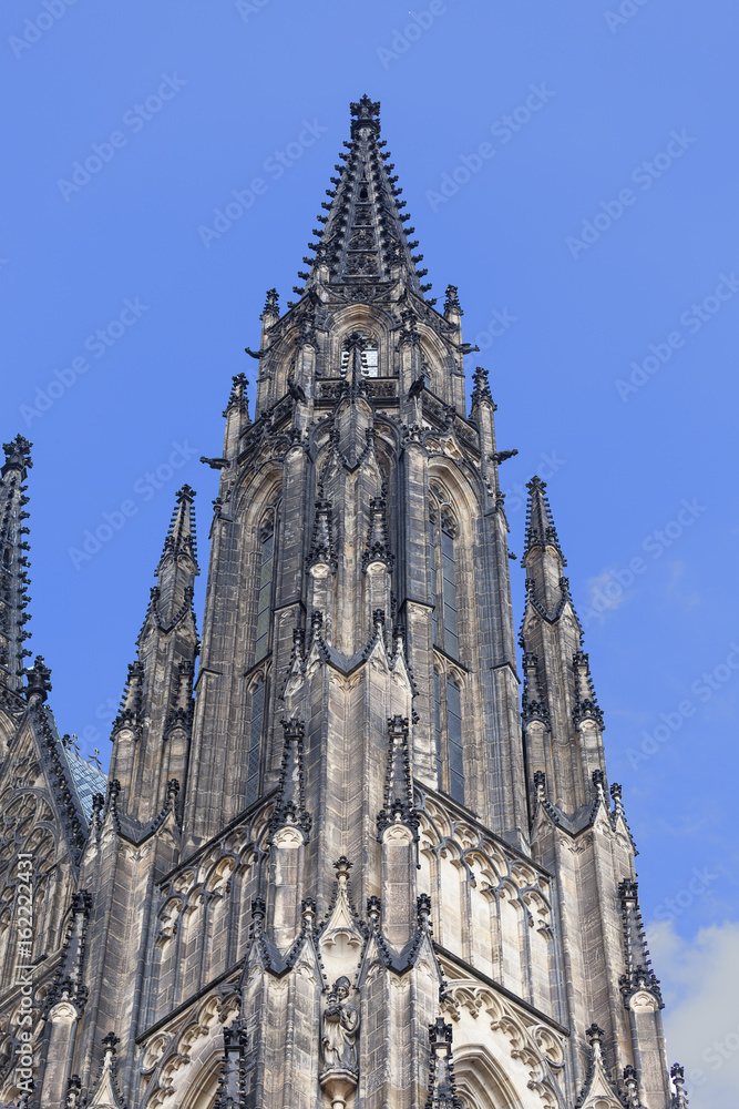 14th century St. Vitus Cathedral on a background of blue sky, Prague, Czech Republic.