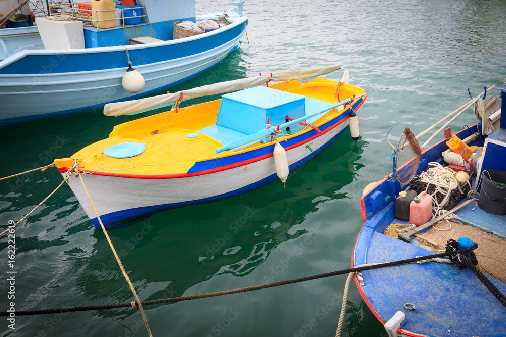 Colorful Greek fishing boats in port of Kardamena in Kos island, Greece.