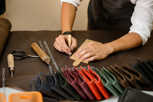 Leather handbag craftsman at work in a workshop