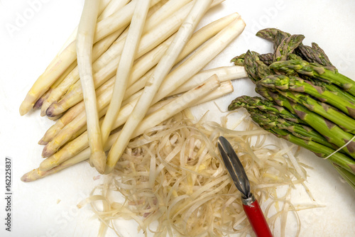 Green and peeled white Asparagus (Asparagus officinalis) in the kitchen