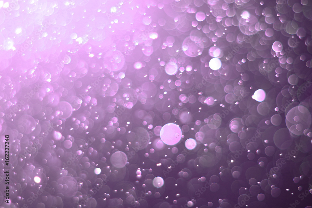 A beautiful and blurry bokeh on a purple background.