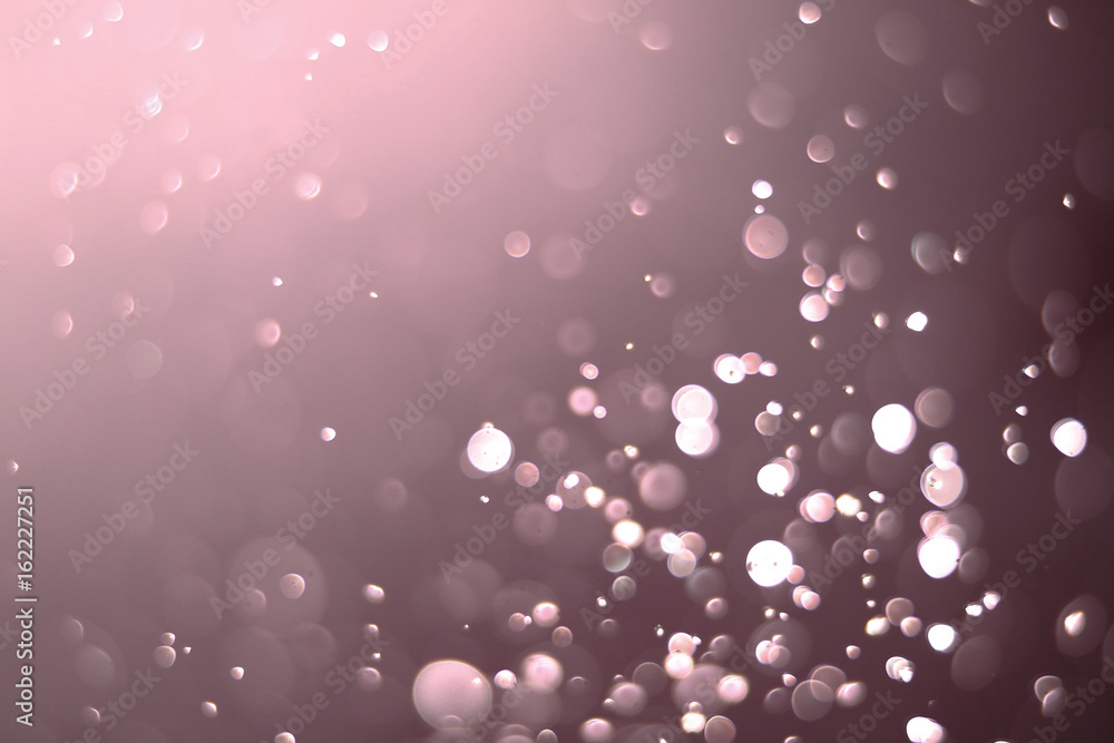 Beautiful and blurry bokeh on a pink background.