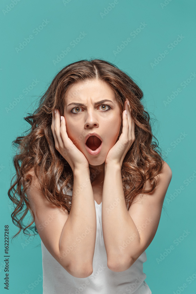 Portrait of young woman with shocked facial expression Portrait of young woman with shocked facial expression