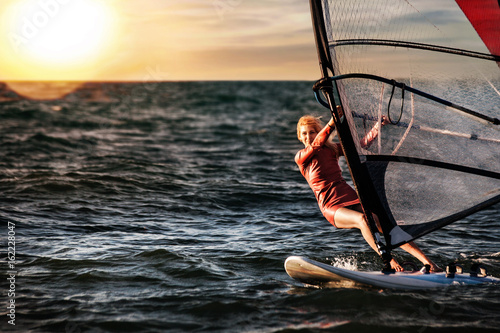 Windsurfing, Fun in the ocean, Extreme Sport. Woman lifestyle