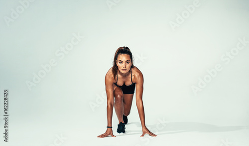 Confident female athlete ready for running