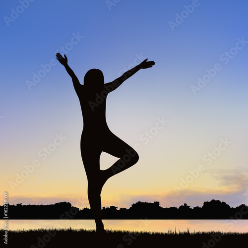 Lady silhouette image in the posture of Yoga.
