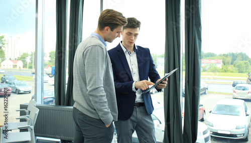 Two businessman dicussing business in the office. photo