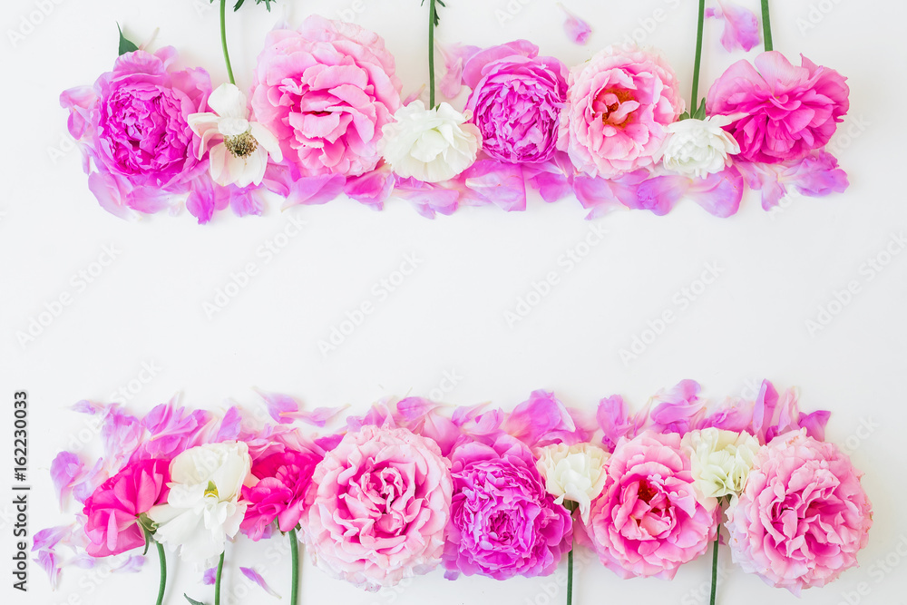 Floral frame of pink roses and white ranunculus on white background. Floral composition. Flat lay, top view