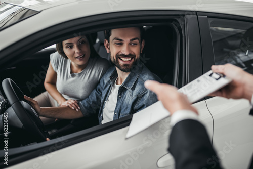 Couple at car dealership