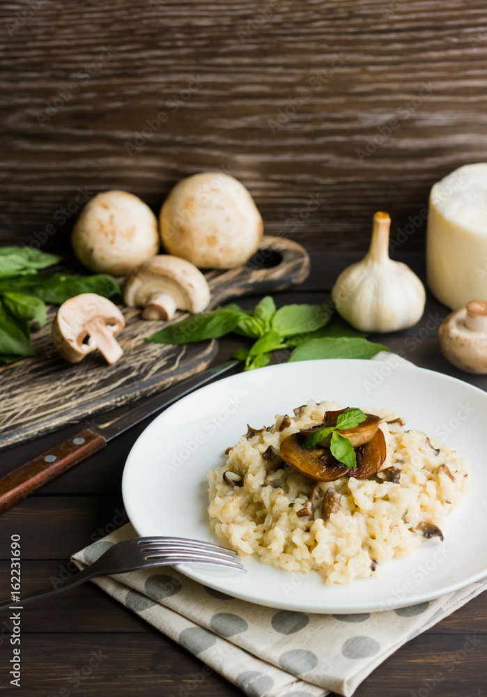 Risotto with mushrooms on a dark wooden background Risotto with mushrooms on a dark wooden background
