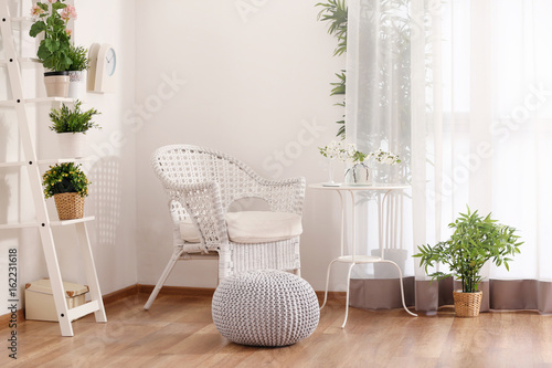 Beautiful modern veranda with cozy furniture and house plants