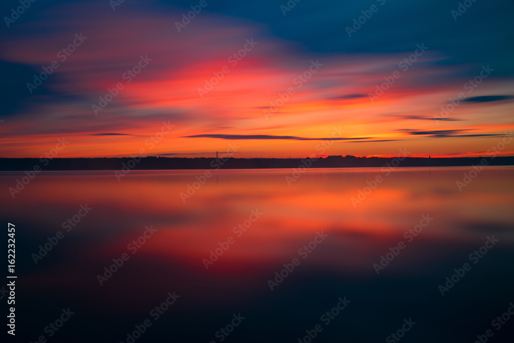 Orange and red sunset at coast of the lake Orange and red sunset at coast of the lake