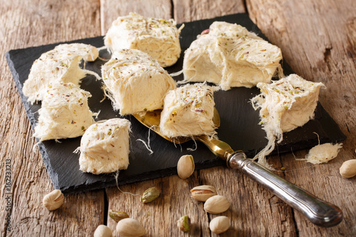 Turkish traditional dessert pismaniye with pistachios close-up. horizontal photo