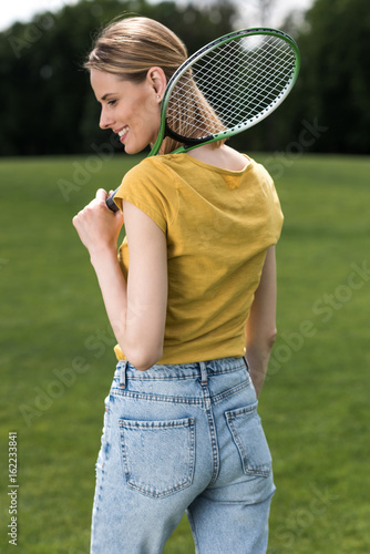 attractive woman holding badminton racquet and looking away © LIGHTFIELD STUDIOS