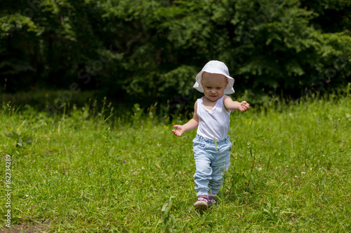 Cute toddler girl running b...