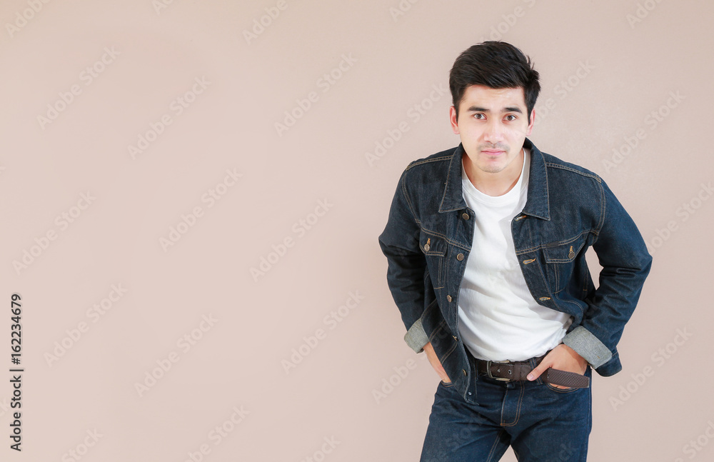 Closeup Asian man casual outfits standing in jeans and black denim shirt, men  black hair and short hair, smiling and wearing jeans jacket, beauty and  fashion concept, and Jeans concept Stock Photo