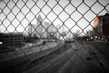 City skyline through the wire mesh fence