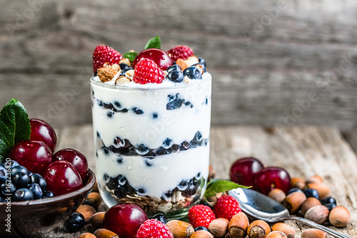 Healthy yogurt with fruits or sundae ice cream in a cup, summer dessert concept