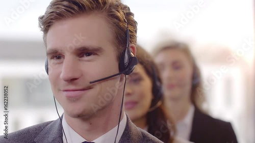 Call Centre Agents working in their bright office Friendly Call Centre Agents working in their office. Shot in 4k with a red dragon down convert to HD.