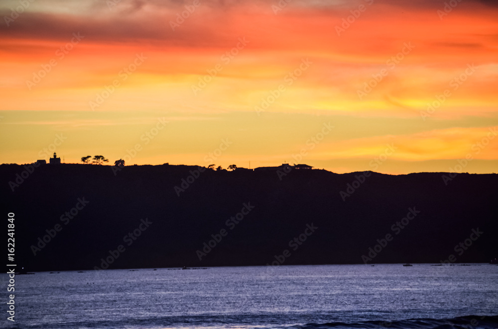 Colorful sunset on Coronado island with silhouettes of Cabrillo National Monument in San Diego, California