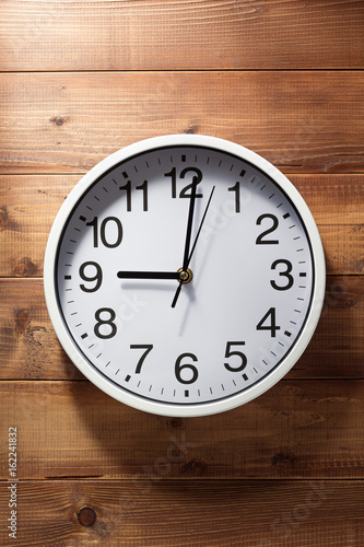 wall clock at wooden background