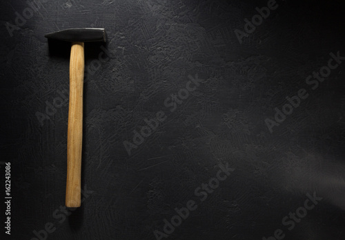 hammer tool on black .