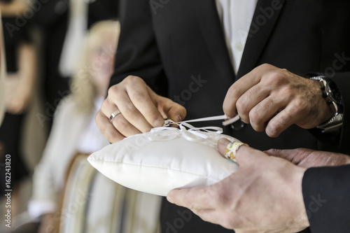 Ring is pinned during a wedding ceremony
