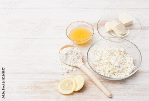 Ingredients for baking cottage cheese on a white table