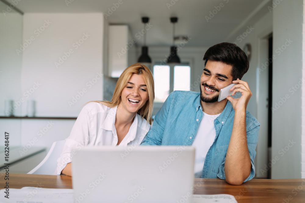 Handsome young man and attractive woman working on laptop Handsome young man and attractive woman working on laptop