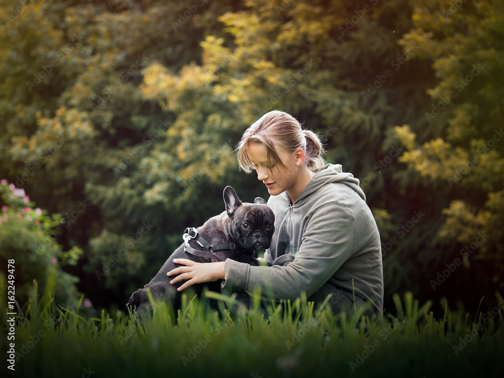 Girl hugging a dog. Nature, green grass, beautiful