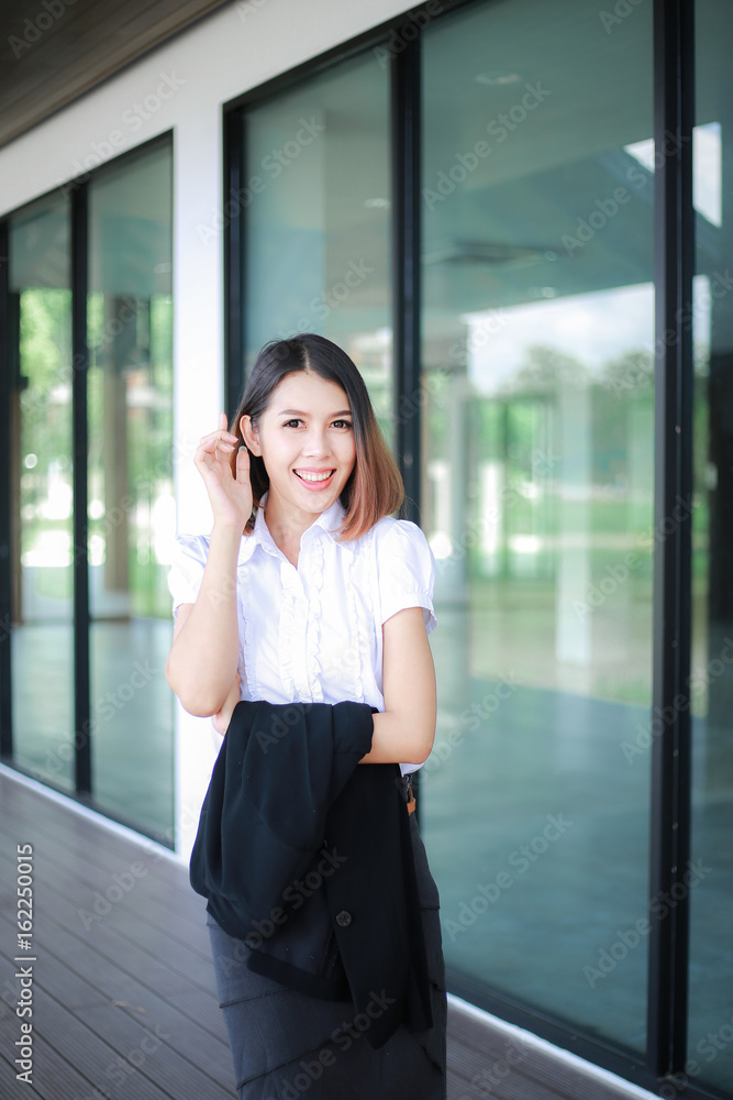 Modern business women casual outfits in the office with copy space, Business woman standing cross one's arm, Asian people young beautiful businesswoman smile. business concept Modern business women casual outfits in the office with copy space, Business woman standing cross one's arm, Asian people young beautiful businesswoman smile. business concept