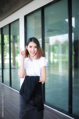 Modern business women casual outfits in the office with copy space, Business woman standing cross one's arm, Asian people young beautiful businesswoman smile. business concept