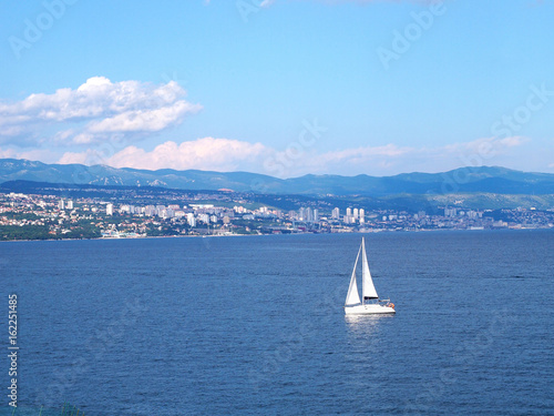 Sailing boat in Adriatic sea, view of Rijeka from Opatija, Croatia